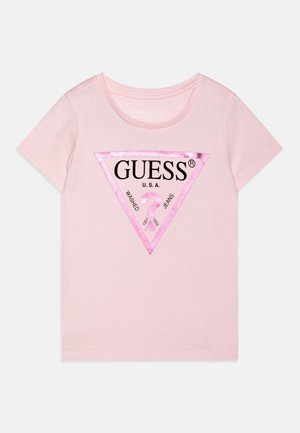 Light pink short-sleeve T-shirt with a metallic pink triangle logo stating "GUESS U.S.A. Washed Jeans" and a question mark inside the triangle.