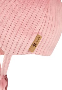 Pink ribbed knit baby hat with ear flaps and a brown tag labeled "Sterntaler."