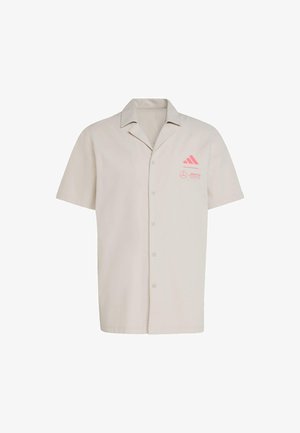 Short-sleeve button-up shirt in light beige fabric. Features pink Adidas and Mercedes logos on the left chest. Standard collar design.