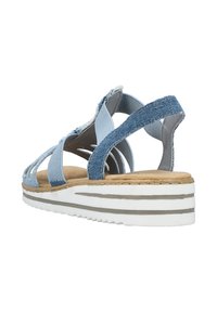 Denim wedge sandals with cross straps, light blue upper, beige textured footbed, and a white platform sole featuring gray stripes.