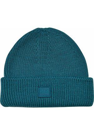 Teal knit beanie with a ribbed texture and a folded cuff. Features a square patch labeled "URBAN CLASSICS" in a contrasting color.