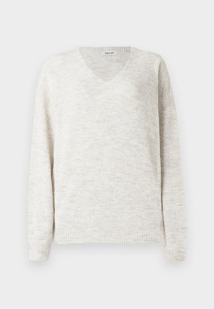 Džemper s V-izrezom u svijetlo bež boji s mekanim teksturiranim završetkom. Ima duge rukave i rebraste manžete te donji rub za prilagođeni izgled.