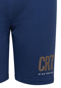 Granatowe bawełniane szorty o dopasowanym kroju, z brązowym logo "CR7" i napisem "NIGHTWEAR" w kolorze białym.