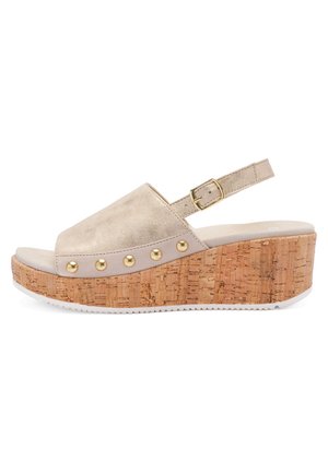 Beige open-toe wedge sandal with cork platform sole, gold studs along base, and adjustable ankle strap with gold buckle.