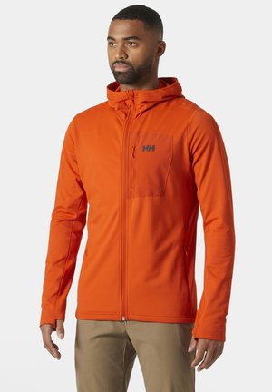 Oranje hoodiejack gemaakt van lichtgewicht, gestructureerde stof. Heeft een rits aan de voorkant, een borstzak met logo en fitted manchetten voor een snug fit.