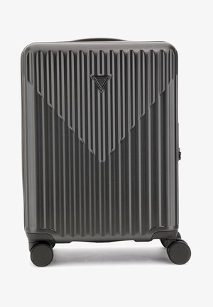 Hard-shell black carry-on suitcase with vertical grooves, square shape, top handle, and four wheels for mobility. Logo at top.