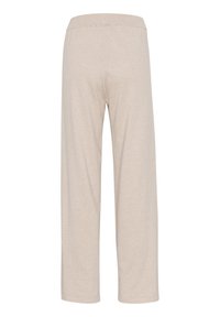 Beige vida byxor i ett mjukt, lätt material. Har en elastisk midja och inga synliga fickor eller dekorationer.
