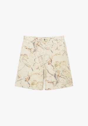 Short beige avec bouton et fermeture éclair, avec un motif floral et de branches abstrait marron clair et gris, poches avant et arrière.