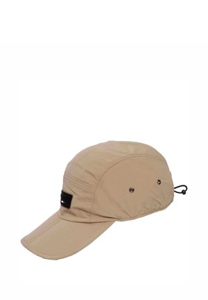 Beige lightweight cap with a curved brim, ventilation holes, black adjustable cord at the back, and a small black logo patch on the side.