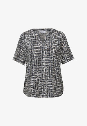 Blouse à manches courtes bleu marine et beige avec décolleté en V et motif floral géométrique, coupe décontractée et ourlet arrondi.