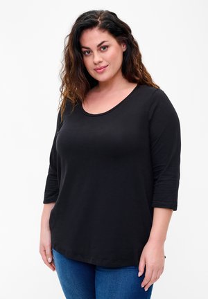 Schwarzes, locker sitzendes T-Shirt mit Rundhalsausschnitt und Dreiviertelärmeln. Glattes Baumwollgewebe, das für Komfort und Bewegungsfreiheit sorgt.