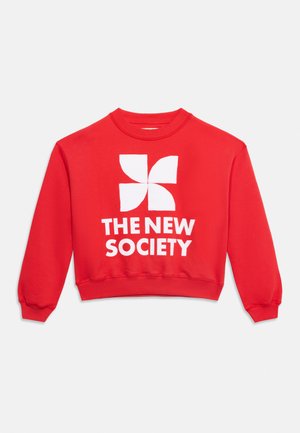 Punane ümara kaelusega dressipluus valge tuuleveski graafikuga teksti "THE NEW SOCIETY" kohal, mis on trükitud esiküljele.