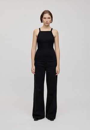 Black sleeveless top with a square neckline, paired with high-waisted black wide-leg jeans, featuring subtle texture and a smooth finish.