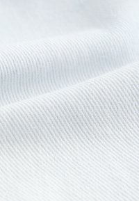 Light blue fabric with a subtle ribbed texture, displaying a soft and smooth appearance. No distinct patterns or accents visible.