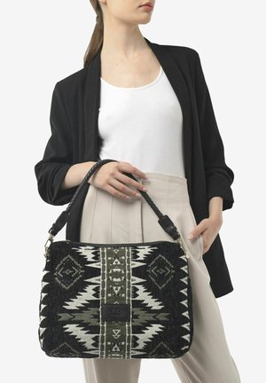 Black and green patterned shoulder bag with a woven texture, featuring a black strap and a logo patch. The bag has a rectangular shape.
