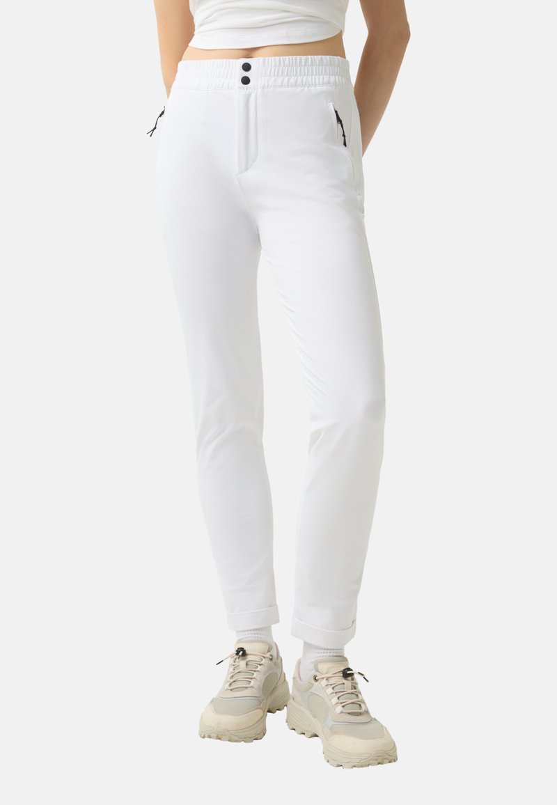 White tapered pants with an elastic waistband, featuring two zippered pockets and black accents. Material appears smooth with a lightweight texture.