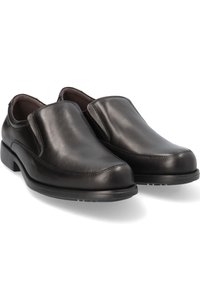 Zapatos negros de piel deslizables con un acabado suave, punta redondeada y tacón bajo de goma. Presentan detalles de costura a lo largo de los bordes.