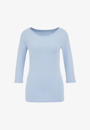 Világoskék, hosszú ujjú felső, lekerekített nyakkivágással, puha anyagból készült, testhez simuló fazonú, varrás nélküli ujjak jellemzik.