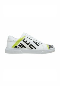 White sneaker with black text and yellow accents. Features a low-top design, rounded toe, and textured sole for grip.