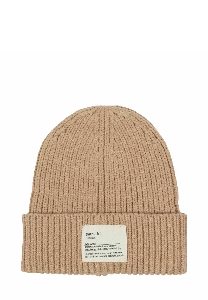 Beige ribbed knit beanie with folded cuff featuring a fabric label defining "thank-ful" and listing synonyms and its meaning.
