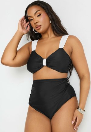 Bañador de dos piezas negro con top de sujetador acolchado anudado y parte inferior de cintura alta; cuenta con tirantes blancos y detalle de fruncido lateral.