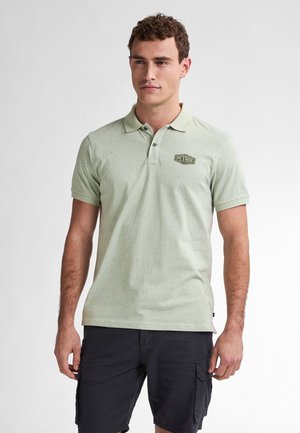 Light green polo shirt with speckled texture, short sleeves, two-button placket, and a small "PETROL" logo on the left chest.