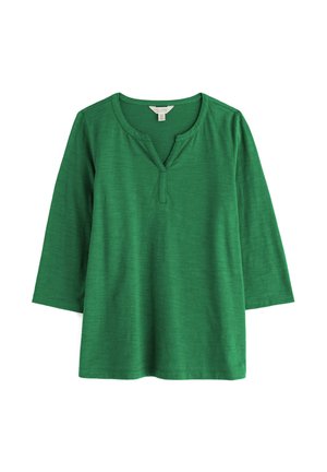 Groen shirt met driekwart mouwen en een inkeping in de hals, gemaakt van zacht, gestructureerd stof, plat weergegeven op een witte achtergrond.