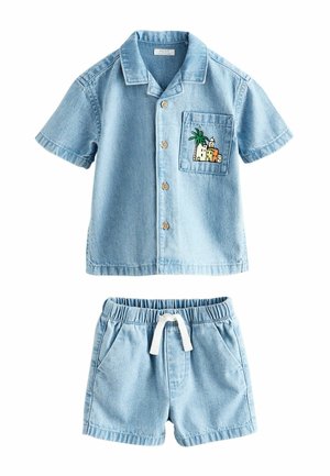 Light blue denim short-sleeve button-up shirt with palm tree and building patch on chest pocket, paired with matching elastic waist shorts.
