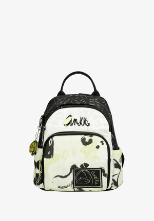 Sac à dos noir et blanc avec des motifs abstraits, doté d'un compartiment zippé, de deux poches latérales et d'un écusson logo. Fabriqué en tissu.