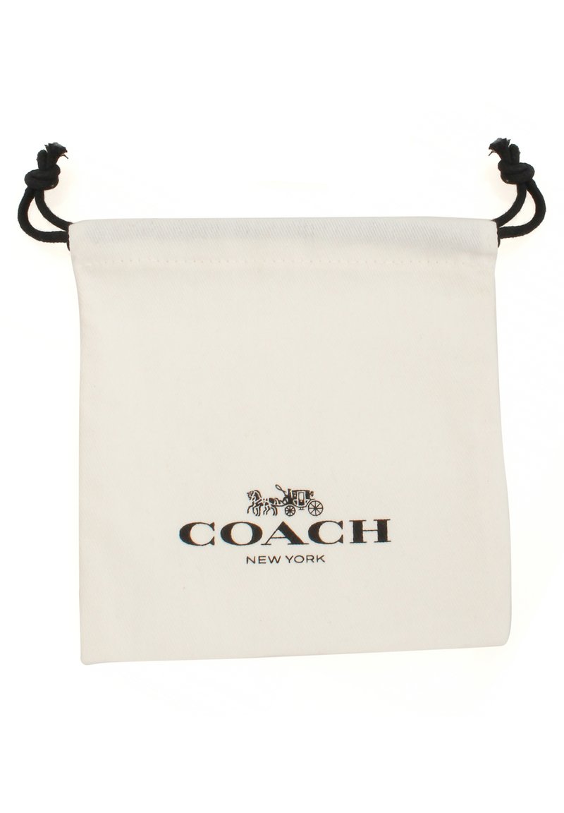 Borsa in cotone bianco con coulisse nera e logo stampato "COACH NEW YORK". Texture liscia con design minimalista.