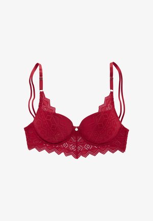 Soutien-gorge en dentelle rouge avec des bonnets rembourrés, des bords en zigzag festonné, un bouton décoratif à l'avant et des bretelles en satin réglables. Motif géométrique complexe sur l'ensemble.