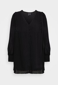 Blusa nera in tessuto leggero con scollo a V, dettagli arricciati sulle spalle, pois testurizzati e chiusura con bottoni davanti.
