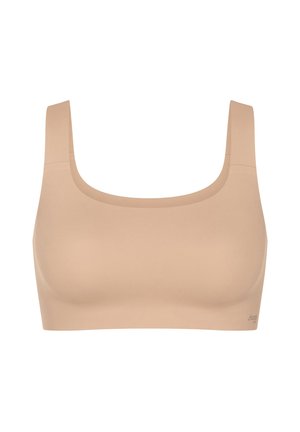 Seamless beige sports bra with wide shoulder straps and a square neckline, designed for comfort and support.