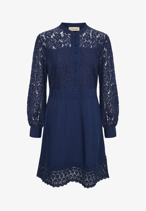 Tamsiai mėlyna suknelė su nėrinių ilgais rankovėmis, sagčių priekyje, apykakle ir nėrinių apdaila apačioje. Pagaminta iš lengvos tekstūruotos medžiagos.