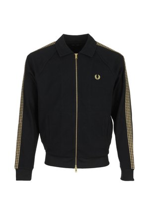 Zwarte jas met rits en kraag, gouden geruite strepen op de mouwen, en een klein goudkleurig lauwerkranslogo op de linkerborst.