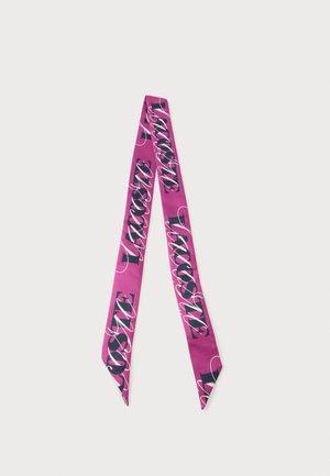 Longue écharpe fine magenta avec un grand motif de texte noir et blanc indiquant "LACOSTE", répété sur toute sa longueur.