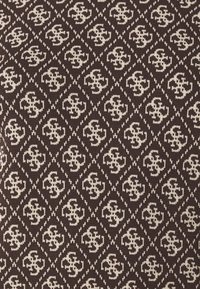 Brown textile featuring a repeated light beige pattern of intertwined shapes, creating a geometric diamond effect across the fabric.