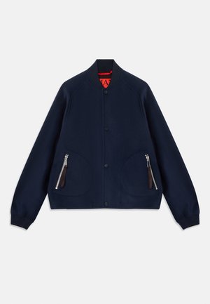 Navy blue bomber jacket with a rounded collar, front button closure, two large side pockets, and a zip pocket. Smooth fabric texture.