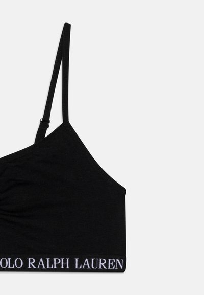 Črna bombažna bralette s enem prilagodljivim naramnicom in širokim pasom, ki vsebuje bel logo "POLO RALPH LAUREN". Gladka tekstura.