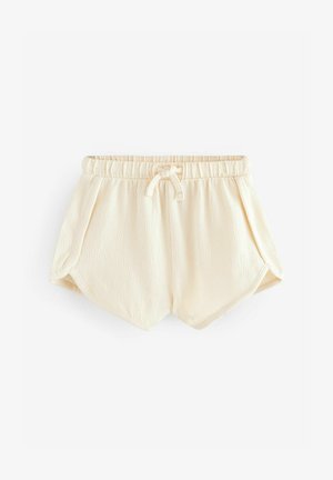 Krema krāsas šorti ar elastīgu jostasvietu, auklu un teksturētu audumu. Iespējas ar slīpām kabatām un brīvu piegriezumu.