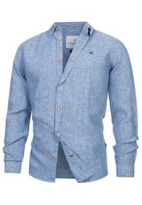 Vaaleansininen pellavapaita, jossa on pitkät hihat, puiset napit, pieni tumma logo rinnassa ja rento avoin kauluksetti.