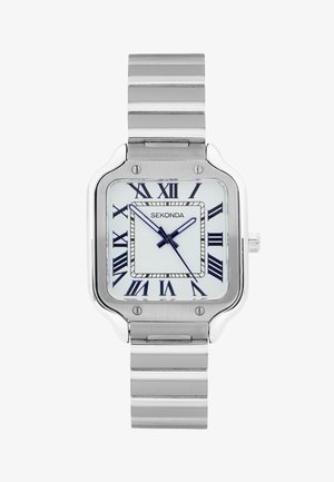 Square silver wristwatch with white face, black Roman numerals, and metal link strap showing 10:10:35 time.