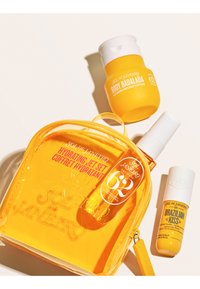 Le coffret soin de la peau jaune Sol de Janeiro comprend le kit Hydrating Jet Set, la lotion Body Badalada et le soin des lèvres Brazilian Kiss, présentés sur un fond clair.