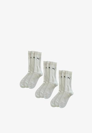 White cotton socks with ribbed cuffs, featuring a black logo. Six pairs included, crew length, smooth texture, and reinforced toe.