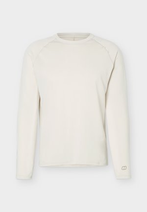 Garām piedurknēm, krēmkrāsas apaļas kakla krekls ar raglāna piedurknēm, minimāls dizains un neliels logotips pie kreisās plaukstas locītavas.