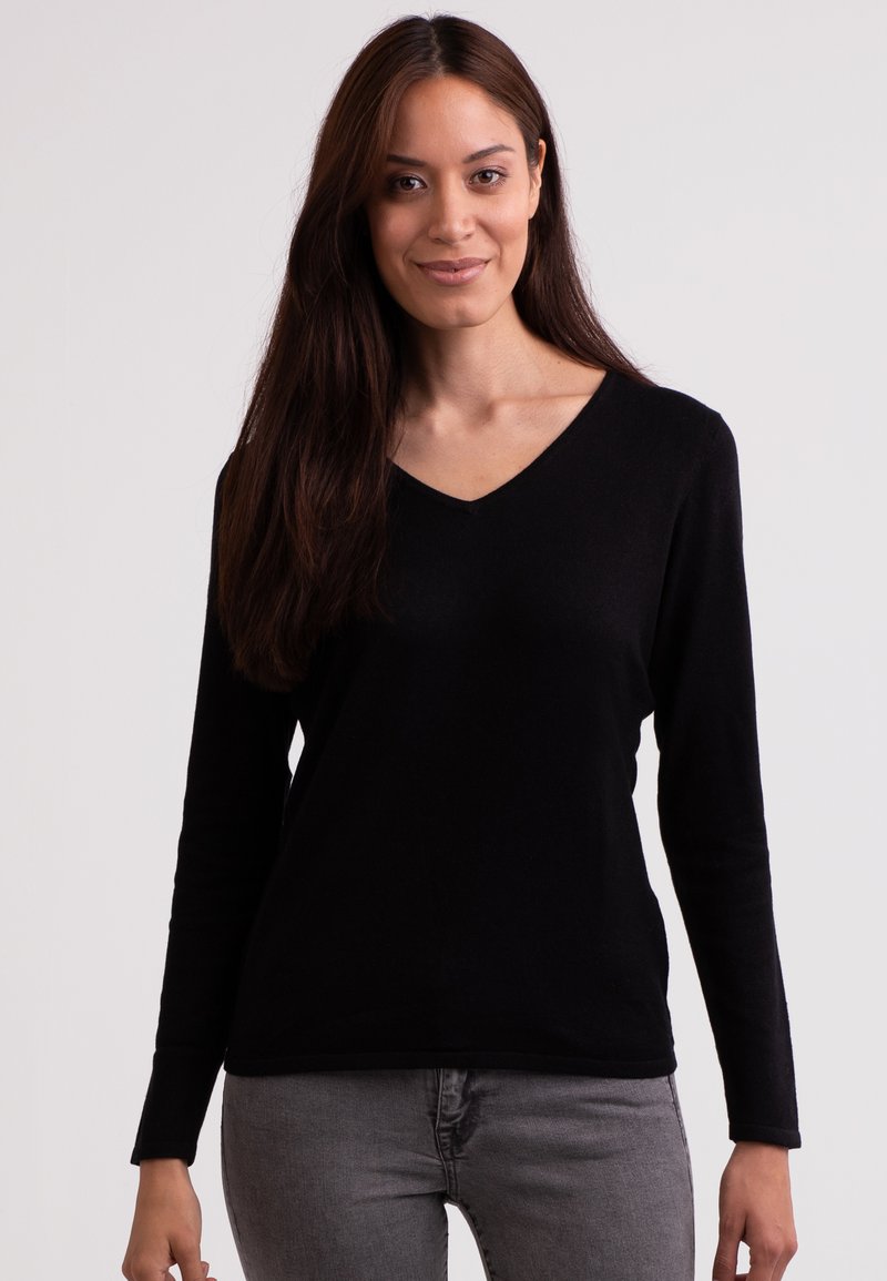 Svart långärmad V-ringad tröja i mjukt material. Har en enkel design, figurnära passform och sömlösa manschetter vid handleden.