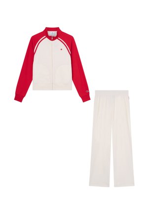 White track jacket with red sleeves and matching white pants, featuring small Champion logos on the chest, sleeve, and pants waistband.