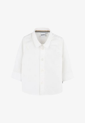 Camicia bianca a maniche lunghe con abbottonatura frontale. Presenta un motivo sottile, dettagli con bottoni e colletto. Logo del marchio all'interno del colletto.