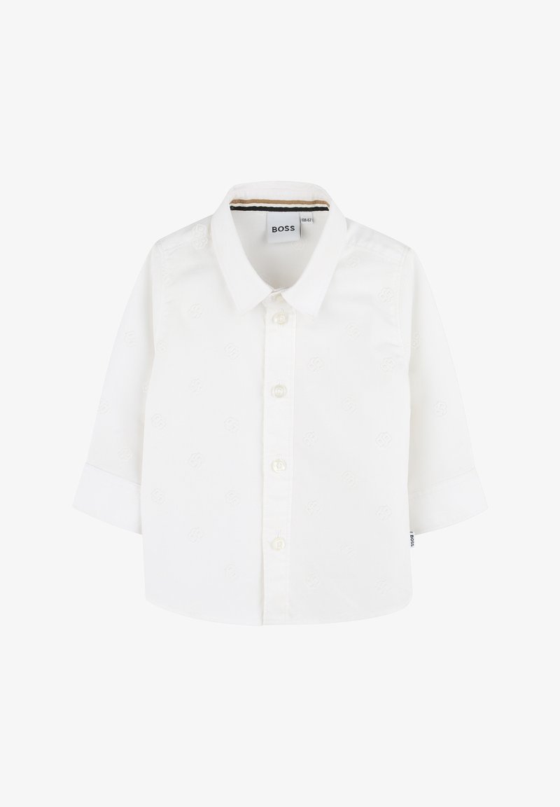 Camicia bianca a maniche lunghe con abbottonatura frontale. Presenta un motivo sottile, dettagli con bottoni e colletto. Logo del marchio all'interno del colletto.