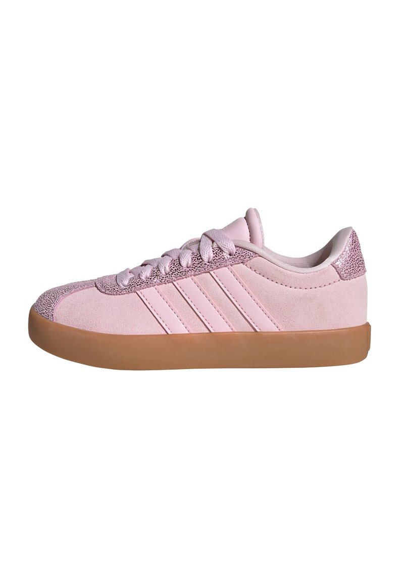 Pink suede sneaker featuring three white stripes, textured pink accent on the heel, and a gum rubber sole. Classic low-profile design.